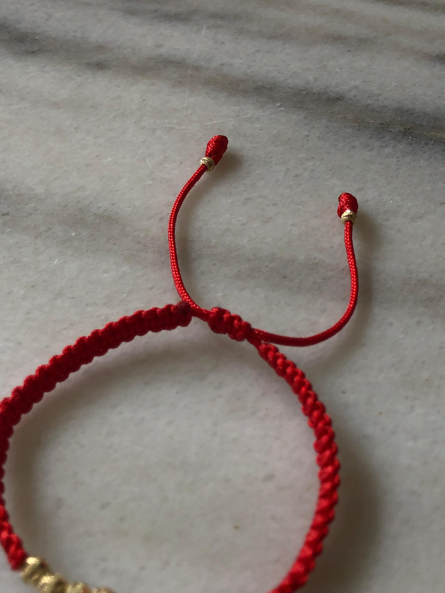 PULSERA TEJIDA EN HILO ROJO ORO 18K